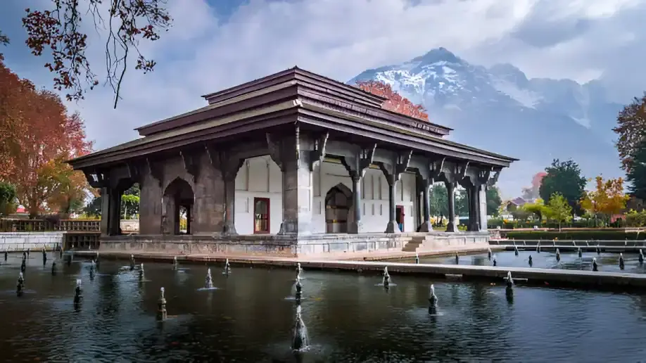 Romantic couple strolling through Shalimar Bagh, Srinagar, amidst vibrant gardens and Mughal fountains, a highlight of Kashmir Nirvana’s Luxury Kashmir Honeymoon Package.